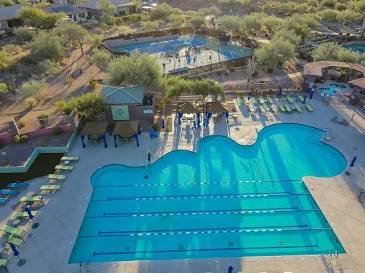 Aerial view of the Anthem Community Center aquatics — lap and leisure pools with the Big Splash water park behind