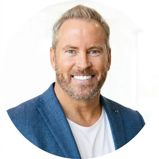 Erik Walbot — headshot in a blue blazer and white tee