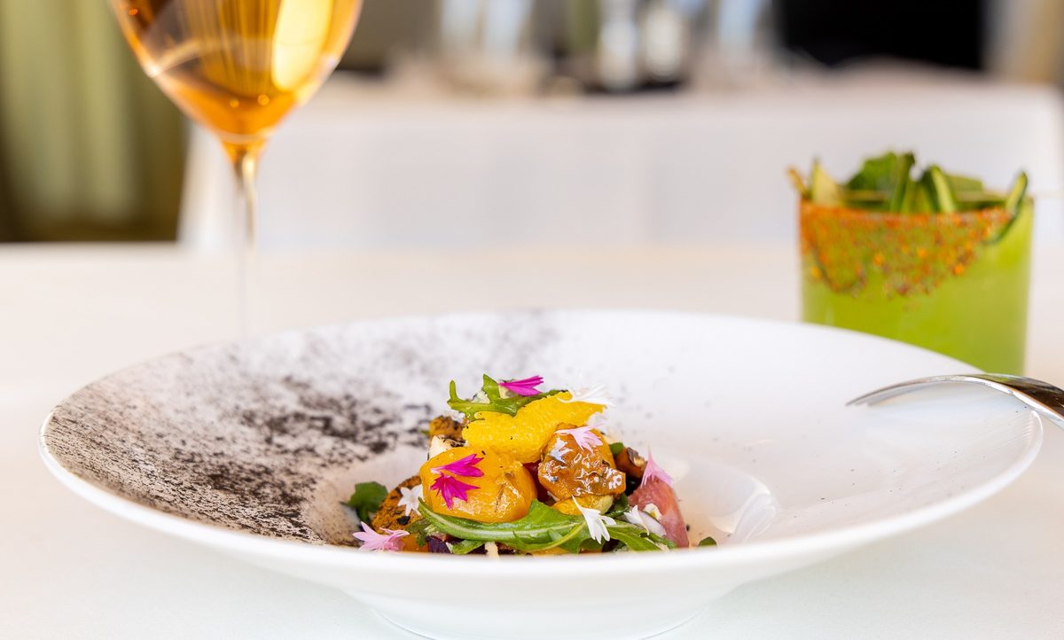Beet and citrus salad plated at Elements at Sanctuary Camelback Mountain, with a glass of rosé